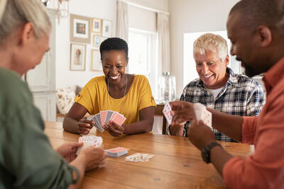 Retired,Multiethnic,People,Playing,Cards,Together,At,Home.,Happy,Senior